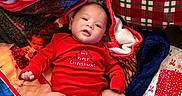 Cylas is registered to the contest to win money with this photo: baby, blanket, celebration, child, christmas, cute, face, festive, gift_wrap, holiday, holiday_season, indoors, infant, lying_down, portrait, presents, red_clothing, smile, socks, soft_texture