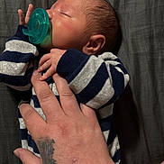 Cylas joined the competition — help win amazing prizes! newborn, baby, sleeping, pacifier, striped_clothing, hand, tattoo, skin, infant, child, person, resting, closeup, indoors, portrait, peaceful, soft_lighting, blanket, comfort, toddler