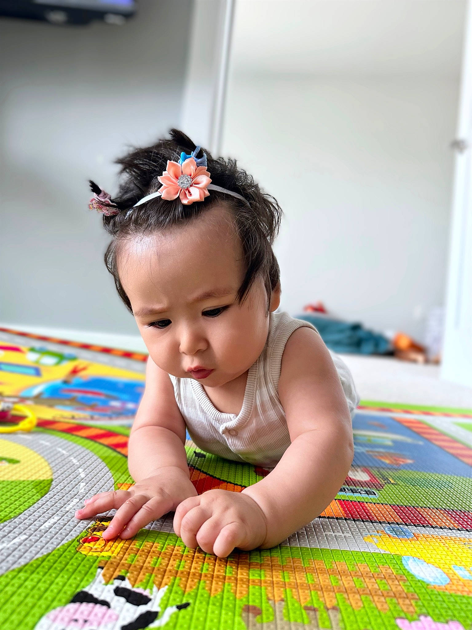 Lali is registered to the contest to win money with this photo: baby, baby_toddler_clothing, child, crawling, dress, fashion_accessory, flooring, fun, grass, happy, headband, headpiece, pattern, person, play, portrait_photography, room, sitting, skin, toddler