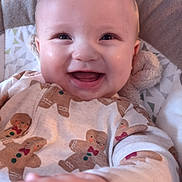 Casper joined the competition — help win amazing prizes! baby, smiling, happy, child, infant, face, hand, clothing, gingerbread_men, onesie, indoors, soft_toy, seat, cute, portrait, closeup, cozy, warm, cheerful, baby_girl