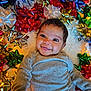 Rebel joined the competition — help win amazing prizes! baby, celebration, cheerful, child, colorful, cute, decorations, face, festive, gift_bows, happy, holiday, indoor, infant, joyful, laying_down, lights, portrait, smiling, warm_lighting