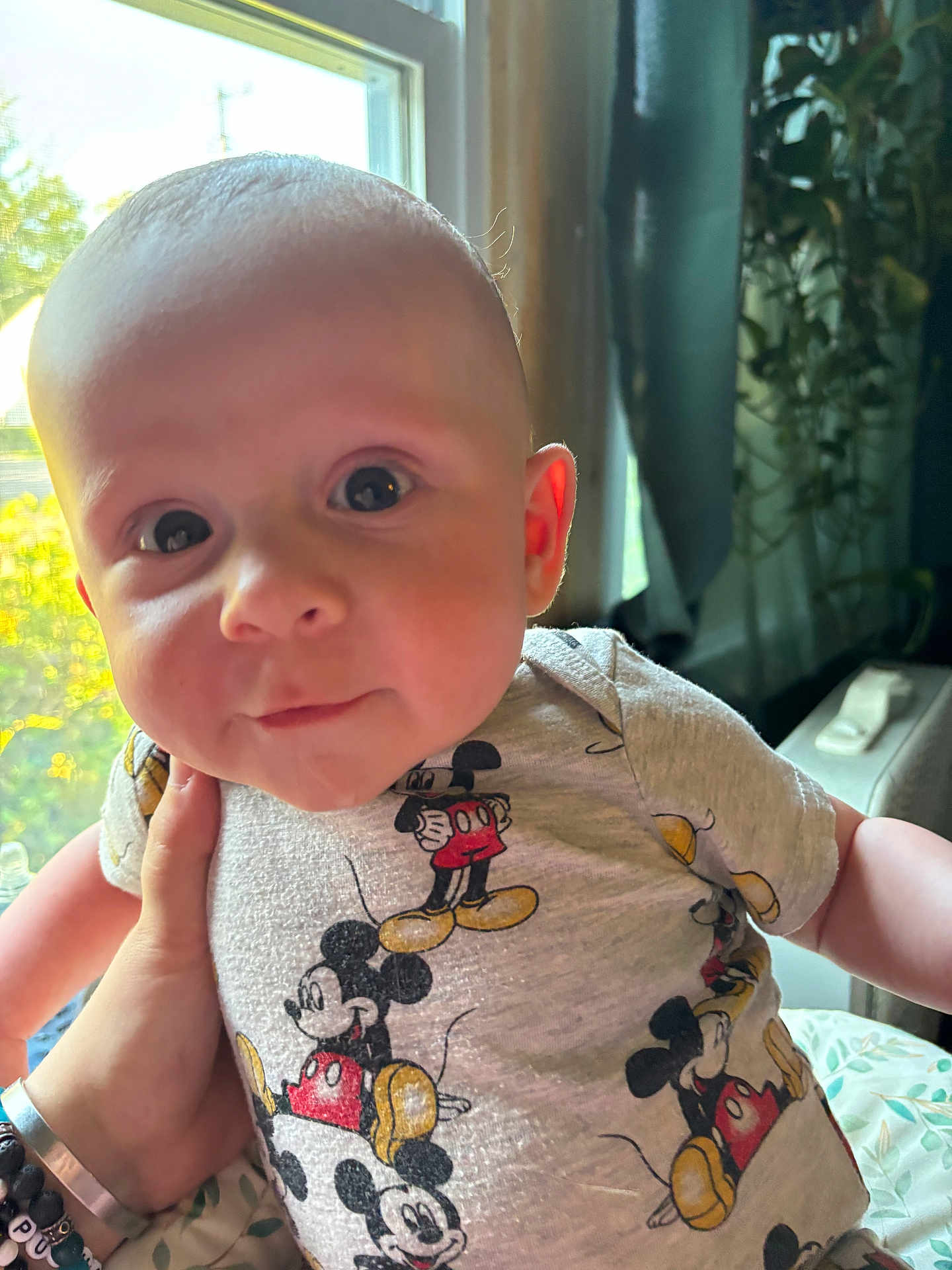 Rhonin joined the competition — help win amazing prizes! baby, child, infant, mickey_mouse, shirt, clothing, hand, window, natural_light, indoors, face, eyes, skin, cute, portrait, person, young, holding, expression, soft_light