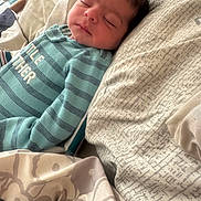 Caleb joined the competition — help win amazing prizes! baby, sleeping, blanket, onesie, striped_clothing, infant, bed, soft_lighting, cozy, child, peaceful, indoors, portrait, face, head, comfort, rest, cute, young, sleep