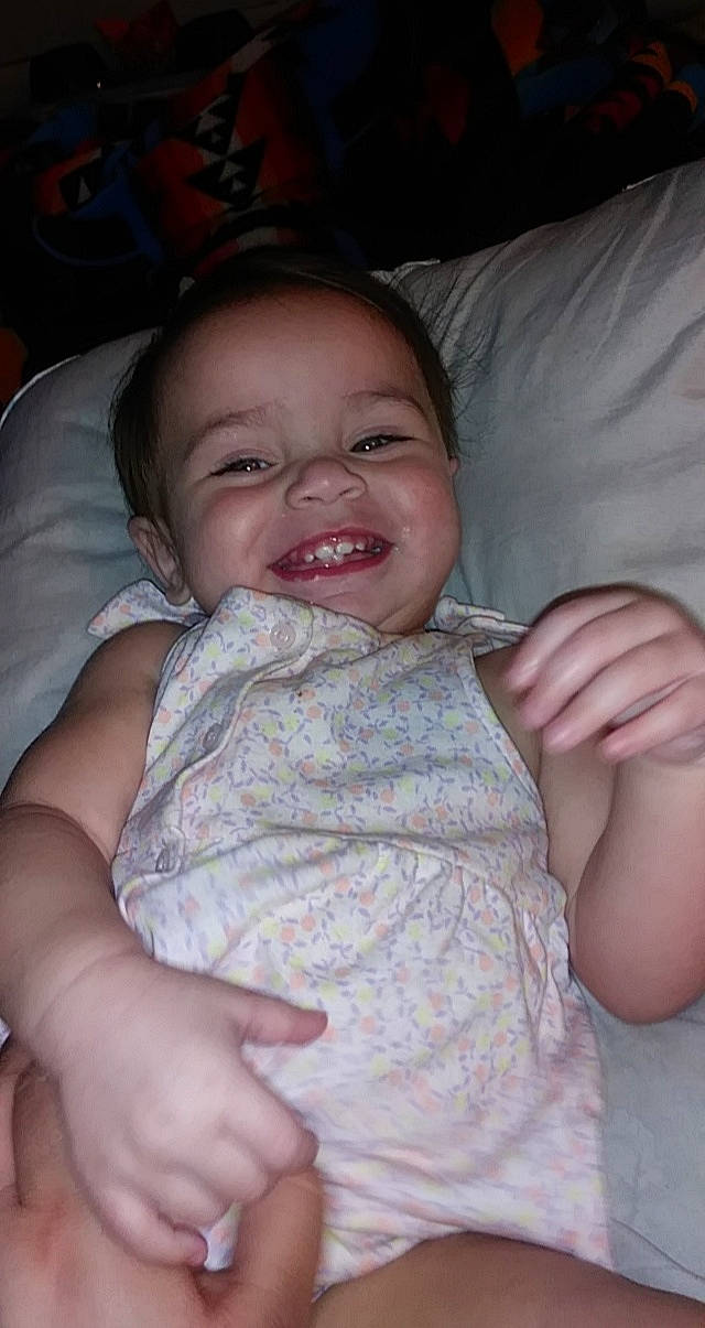 Lillianna joined the competition — help win amazing prizes! baby, baby_toddler_clothing, cheek, child, comfort, facial_expression, finger, hand, iris, joy, laugh, linens, nail, nose, organ, person, skin, smile, thumb, toddler