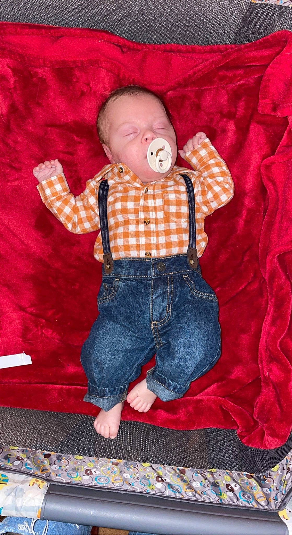 Callahan joined the competition — help win amazing prizes! baby, baby_toddler_clothing, collar, comfort, doll, hand, jeans, orange, pattern, person, pink, plaid, red, shirt, sleeve, t_shirt, tartan, textile, toddler, toy