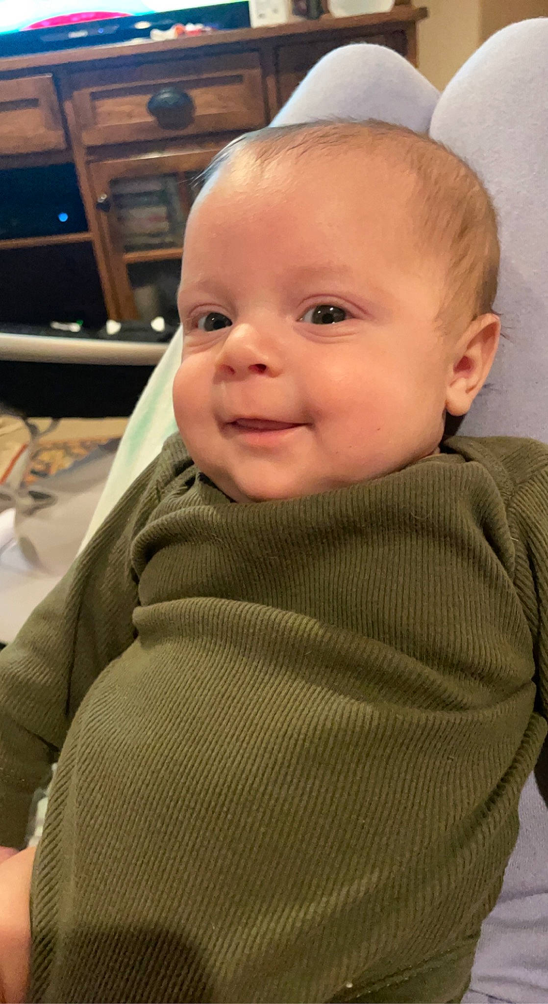 Callahan is registered to the contest to win money with this photo: baby, baby_toddler_clothing, cheek, chin, comfort, eyebrow, face, facial_expression, forehead, head, iris, joy, lip, neck, nose, outerwear, person, skin, sleeve, smile