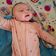 Willow is registered to the contest to win money with this photo: baby, infant, child, smiling, lying_down, portrait, pink_outfit, onesie, zipper, blanket, cartoon, mickey_mouse, minnie_mouse, colorful, nursery, indoor, face, head, happy, baby_photo