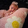 baby, infant, child, pink, dress, tutu, hair_bow, blanket, pillow, portrait, lying_down, indoors, cozy, cute, smiling, face, eyes, hand, soft_texture, pink_and_white