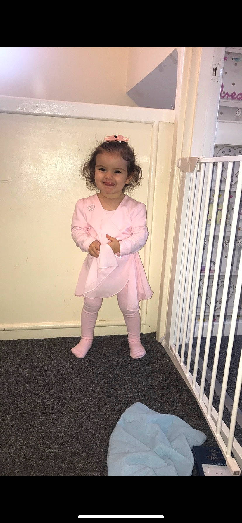 Lola joined the competition — help win amazing prizes! baby, baby_products, baby_safety, baby_toddler_clothing, child, costume, floor, furniture, infant_bed, joy, leg, nursery, person, pink, product, room, sitting, standing, toddler