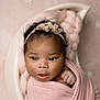 Jream is registered to the contest to win money with this photo: baby, newborn, infant, face, headband, pink_blanket, wrapped, sleeping, cute, portrait, close_up, soft_texture, curly_hair, cozy, crescent_bed, star_pattern, background, peaceful, child, indoors