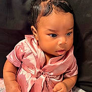 Jream joined the competition — help win amazing prizes! baby, child, pink_dress, bow, curly_hair, sitting, portrait, cute, infant, clothing, soft_texture, indoors, young_child, closeup, adorable, skin, hand, face, expression, dark_background