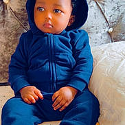 Aizeyosabor joined the competition — help win amazing prizes! bed, blue_hoodie, casual_clothing, child, cozy, curly_hair, cute, face, headboard, indoor, person, pillow, portrait, resting, shoes, sitting, soft_furniture, thoughtful, toddler, young_child