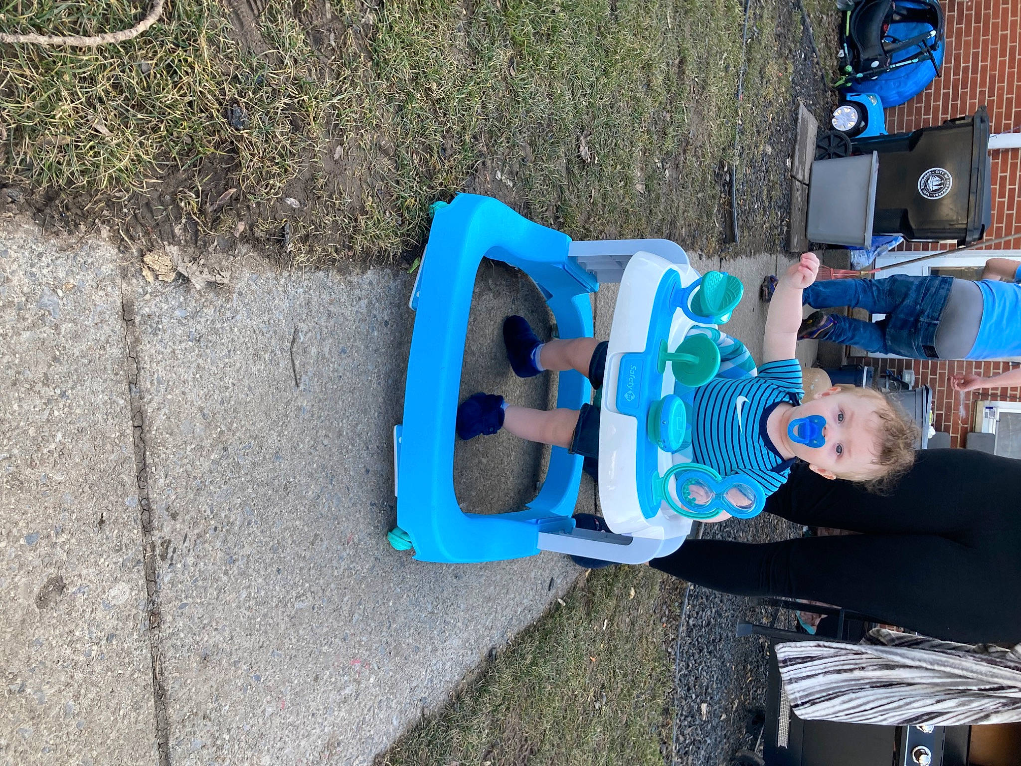 Kingston is registered to the contest to win money with this photo: asphalt, auto_part, automotive_exterior, automotive_tire, bumper, concrete, electric_blue, fun, grass, leisure, machine, person, recreation, road_surface, sidewalk, soil, t_shirt, tar, toddler, walking_shoe