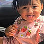 Naomi is registered to the contest to win money with this photo: child, toddler, girl, pink_clothing, pigtails, hair_clips, strawberry_embroidery, playful, tongue_out, smiling, face, portrait, car_interior, seat, sunlight, cute, happy, baby, clothing, closeup