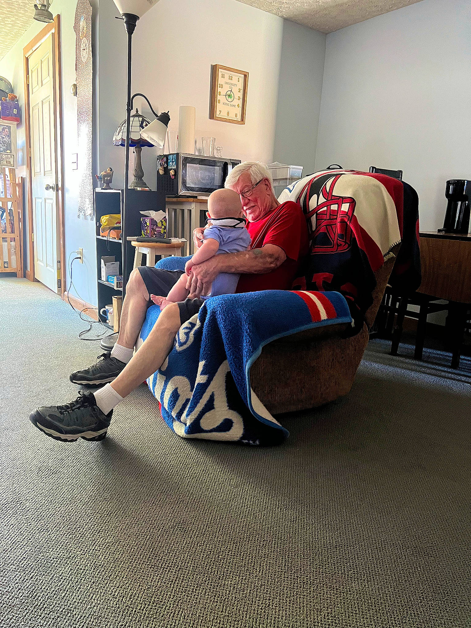 Dj joined the competition — help win amazing prizes! carpet, chair, comfort, electric_blue, event, floor, flooring, furniture, hardwood, human_leg, joint, knee, leg, leisure, living_room, luggage_and_bags, person, picture_frame, sitting, t_shirt