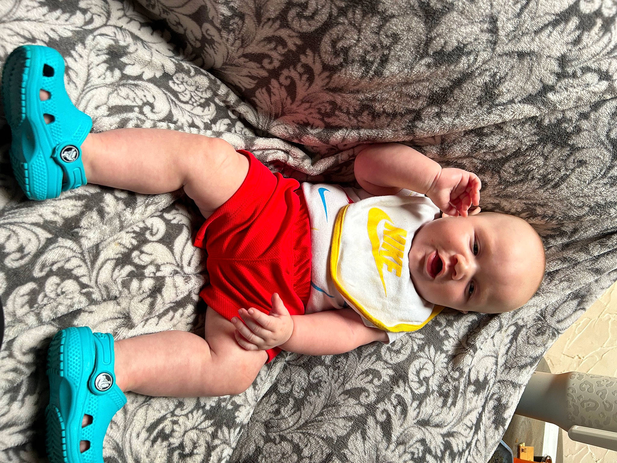 Daniel is registered to the contest to win money with this photo: arm, baby, baby_toddler_clothing, child, comfort, finger, green, hand, happy, human, human_body, joint, leg, leisure, muscle, person, product, skin, textile, thigh