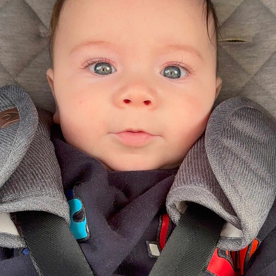 Luca joined the competition — help win amazing prizes! accessories, baby, belt, bodypart, car, car_interior, carseat, clothing, coat, face, finger, head, jacket, pants, person, photography, portrait, strap, transportation, vehicle