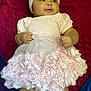 baby, child, pink_dress, headband, roses, blanket, infant, cute, chubby_cheeks, smiling, lying_down, soft_fabric, indoors, portrait, adorable, young_child, clothing, hands, legs, happy