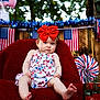 baby, child, red_bow, red_blanket, chair, american_flag, patriotic, decoration, outdoor, summer, cute, portrait, infant, dress, foot, expression, holiday, celebration, bottle, coca_cola