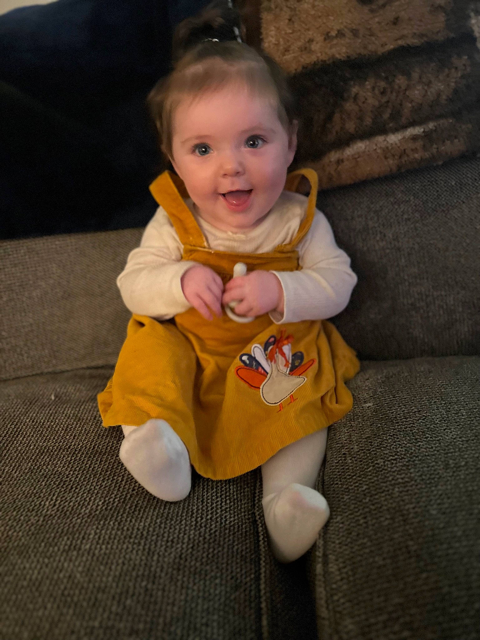 Oakleigh is registered to the contest to win money with this photo: arm, baby, baby_toddler_clothing, cheek, dress, eye, face, facial_expression, finger, flooring, hand, happy, head, iris, nose, person, skin, sleeve, smile, toddler