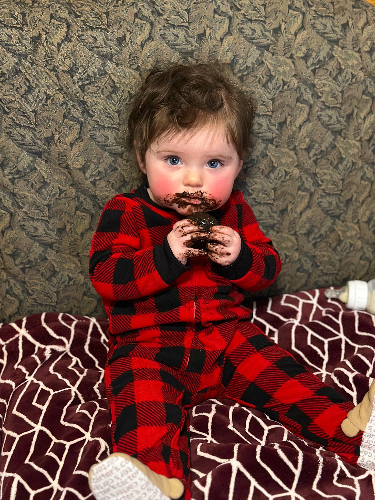 Oakleigh is registered to the contest to win money with this photo: baby_toddler_clothing, carmine, child, couch, day_dress, design, dress, fictional_character, formal_wear, fur, linens, pattern, person, plaid, sitting, sleeve, sock, tartan, toddler, tree