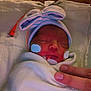 Danessica is registered to the contest to win money with this photo: newborn, baby, hospital, crib, blanket, hat, peace_sign, medical_tape, medical_tube, sleeping, infant, person, hand, cozy, cute, face, swaddled, healthcare, bed, closeup
