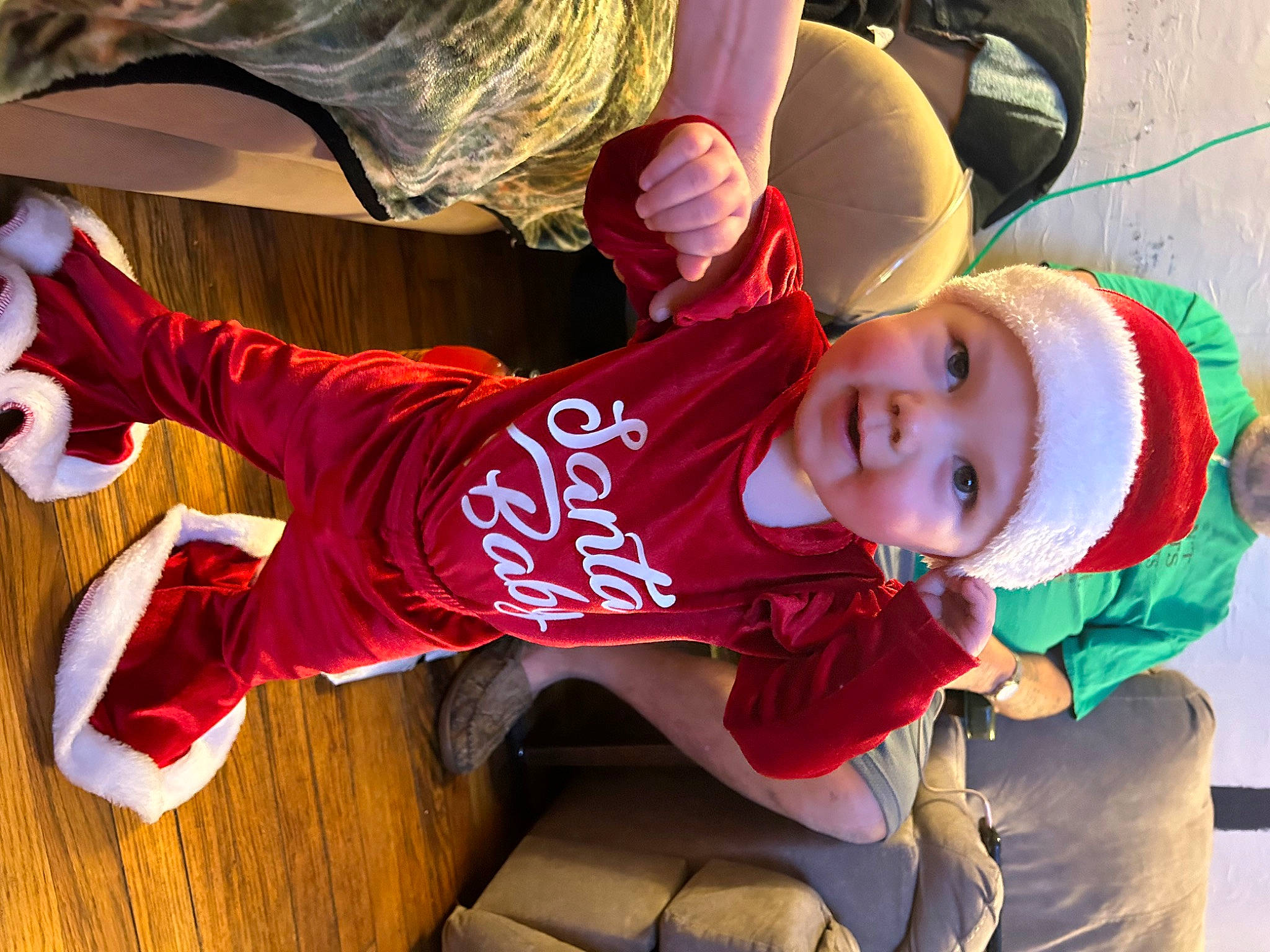 Amaryllis is registered to the contest to win money with this photo: baby, carmine, child, costume, event, fun, happy, hat, headwear, leisure, mouth, person, play, sitting, sleeve, smile, sportswear, t_shirt, toddler, tree