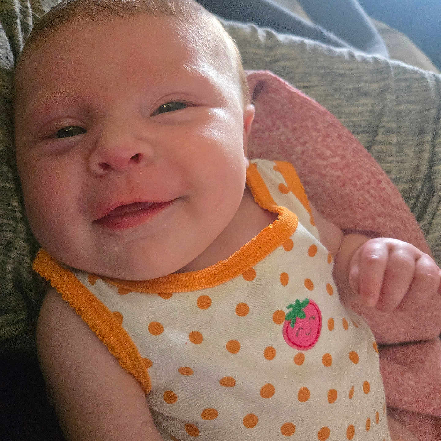 April joined the competition — help win amazing prizes! baby, smiling, face, infant, polka_dot, onesie, strawberry, blanket, hand, skin, cute, closeup, expression, cheeks, person, newborn, soft_light, texture, cozy, indoors