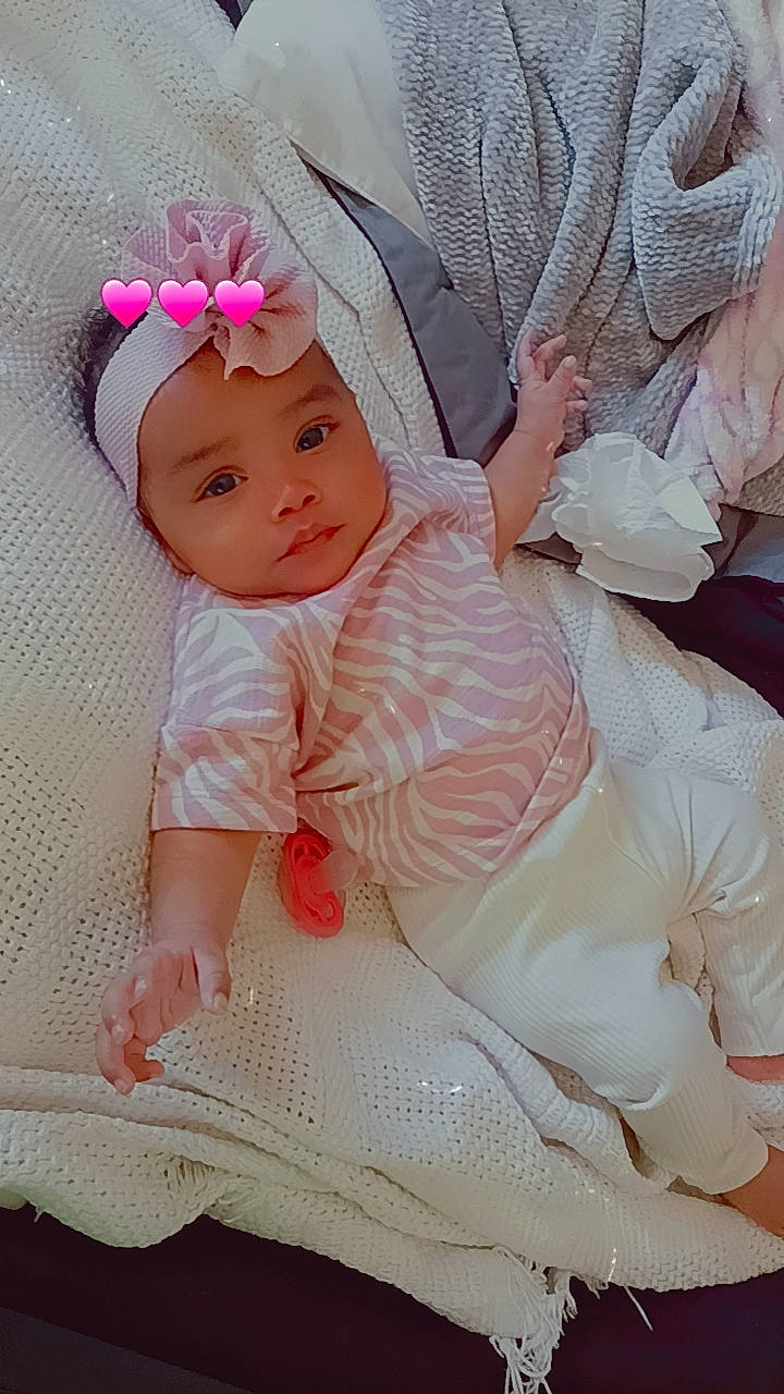 Anabella joined the competition — help win amazing prizes! arm, baby, baby_products, baby_toddler_clothing, cheek, child, comfort, embellishment, eye, fashion_accessory, hair_accessory, hand, headgear, headwear, iris, pattern, person, pink, sitting, skin