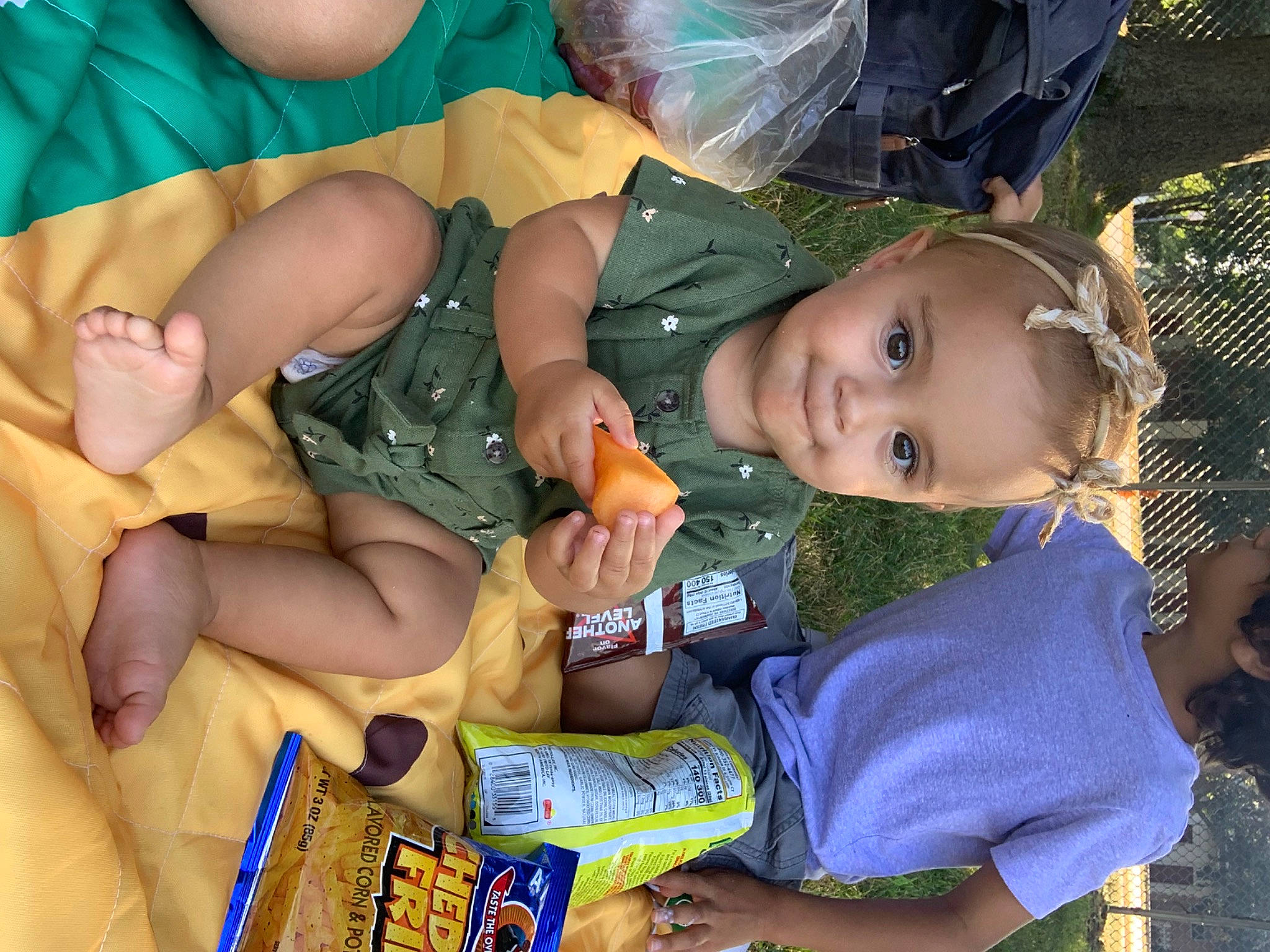 Rhapsody is registered to the contest to win money with this photo: aluminum_can, baby, baby_products, baby_toddler_clothing, blue, child, event, fun, grass, happy, lap, mouth, organ, person, product, sitting, thigh, toddler, tree, vacation