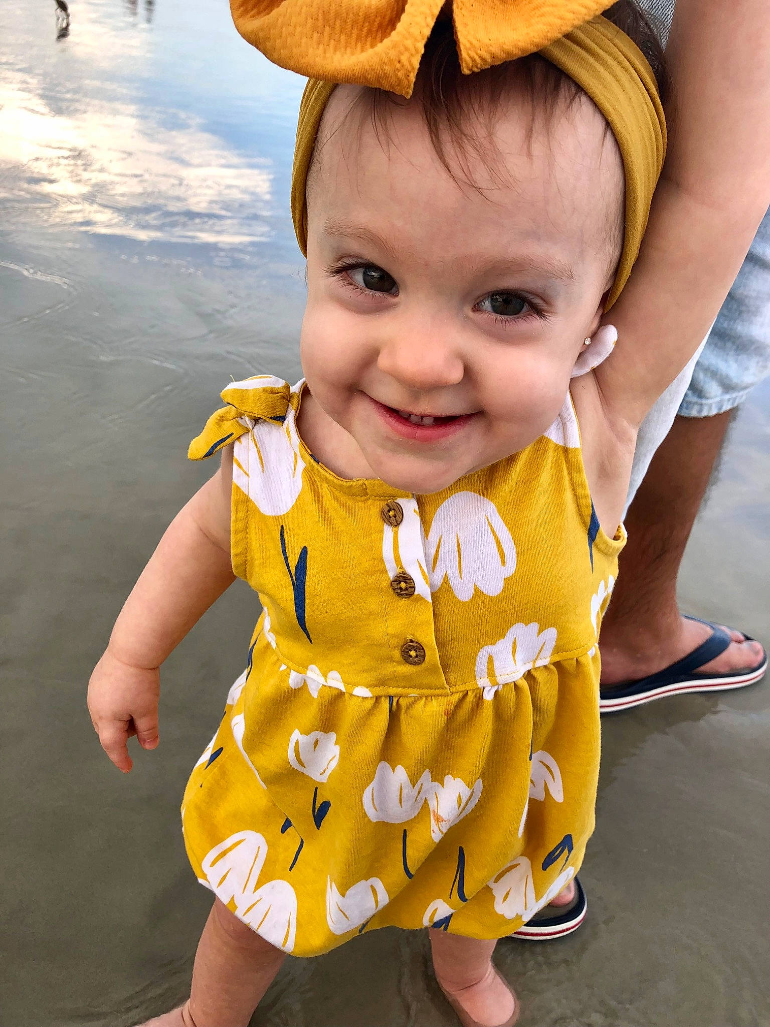 Camille is registered to the contest to win money with this photo: baby, baby_toddler_clothing, cap, event, eye, face, finger, fun, happy, hat, joy, pattern, people_in_nature, person, photograph, skin, sleeve, smile, snapshot, sun_hat