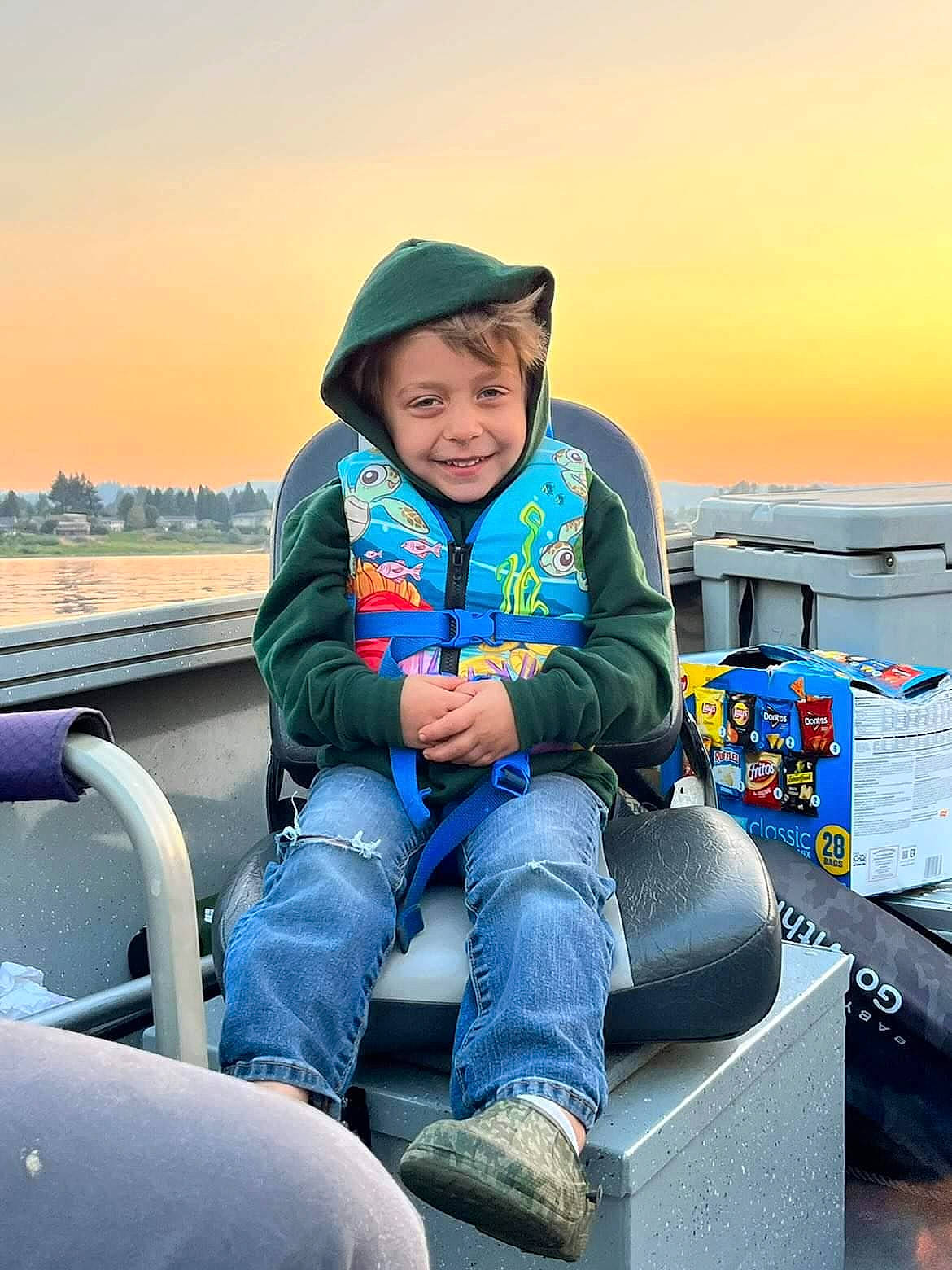 Korbin is registered to the contest to win money with this photo: cap, child, denim, electric_blue, fun, happy, headwear, hoodie, joy, landscape, leisure, luxury_vehicle, ocean, person, recreation, sitting, sky, smile, toddler, tourism