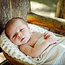 Macklin joined the competition — help win amazing prizes! baby, basket, blanket, child, cozy, eyes, face, hands, infant, lying_down, natural_light, neutral_expression, newborn, outdoor, photography, portrait, rustic, textile, wooden_basket, wrapped