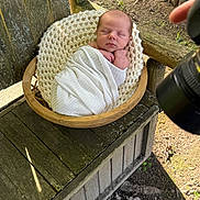 Macklin joined the competition — help win amazing prizes! baby, basket, blanket, camera, cozy, face, head, infant, knitted, nature, newborn, outdoor, peaceful, photography, portrait, rustic, sleeping, sunlight, swaddled, wooden_chair