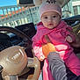 baby, child, pink_clothing, hat, minnie_mouse, car_interior, steering_wheel, audi, person, hand, seat, window, daylight, jeans, sock, cute, infant, portrait, car_dashboard, holding