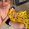 animal, blanket, boy, casual, cat, child, cute, floor, happy, holding, indoor, kitten, pet, pikachu, playful, sitting, smiling, tile_floor, yellow_blanket, young