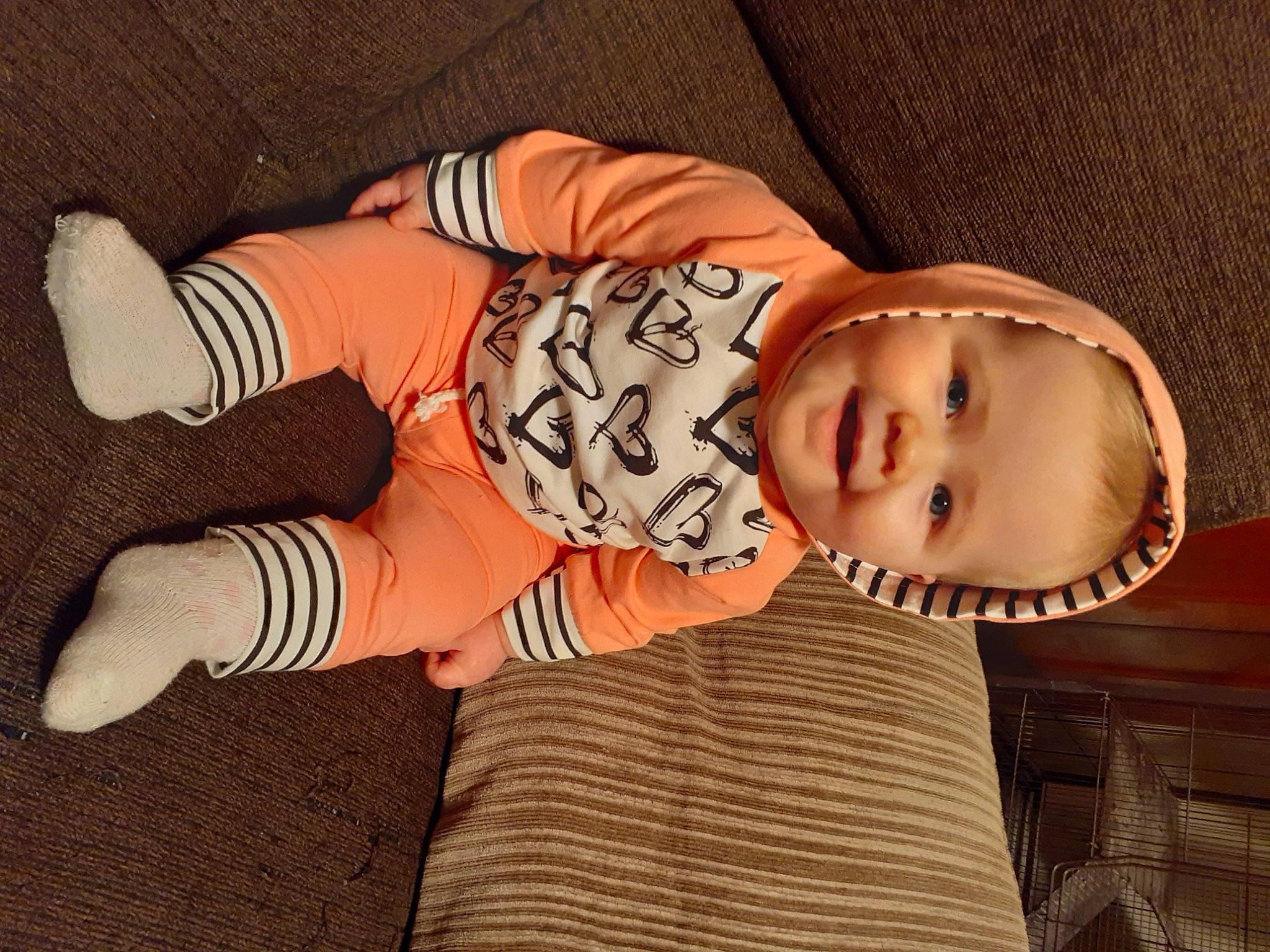 Averie joined the competition — help win amazing prizes! arm, baby, baby_toddler_clothing, cheek, child, comfort, eye, finger, hand, hat, headgear, human_body, joy, orange, person, skin, sleeve, smile, sock, textile