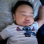 Monie participe au concours pour gagner de l'argent avec cette photo : baby, bed, blanket, cartoon_character, child, closed_eyes, cozy, curly_hair, cute, face, indoor, infant, portrait, relaxed, resting, sleeping, soft_surface, stitch, toddler, white_shirt