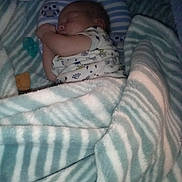 Angel is registered to the contest to win money with this photo: baby, bed, blanket, child, clothing, comfort, cozy, cute, indoor, infant, lying_down, nursery, pacifier, peaceful, pillow, rest, sleeping, soft, striped, young_child