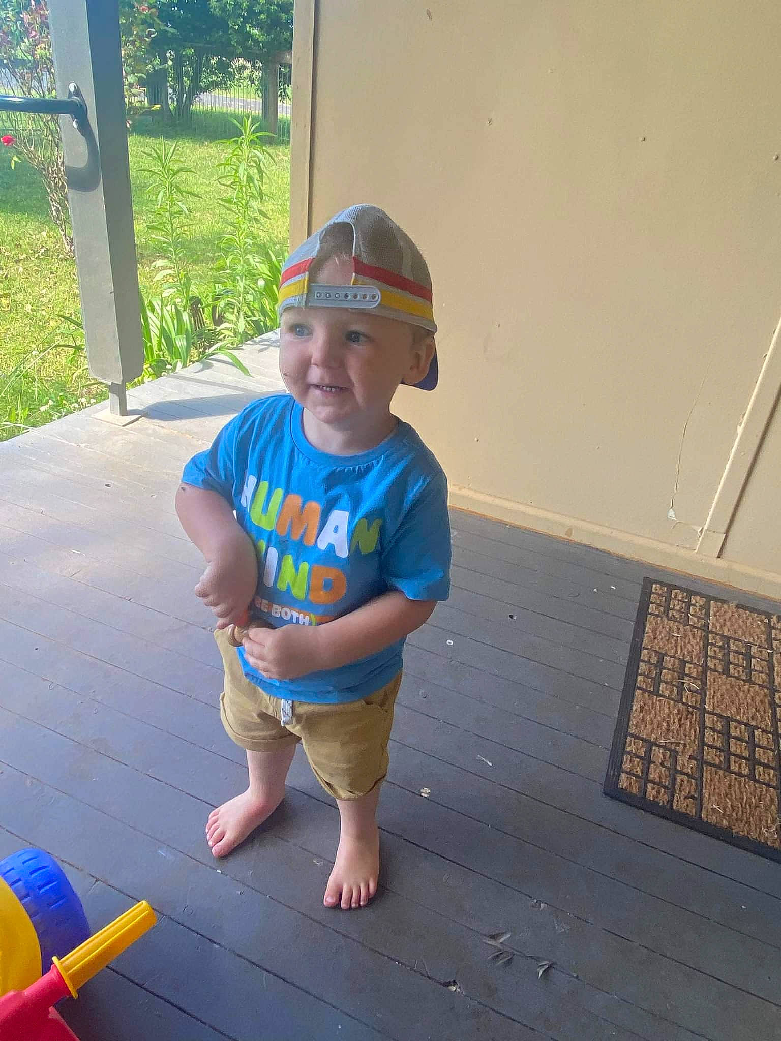 Braxton is registered to the contest to win money with this photo: baby, baby_toddler_clothing, barefoot, baseball_cap, cap, child, electric_blue, flooring, fun, happy, hat, headwear, leisure, person, personal_protective_equipment, plant, recreation, smile, sunglasses, t_shirt