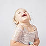 child, girl, laughing, happy, smiling, lace, dress, floral, clothing, portrait, studio, white_background, cute, joyful, blond, person, toddler, emotion, fashion, innocence
