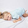 Lorena a rejoint le concours — aidez-le/la à gagner de superbes lots ! child, blonde_hair, smile, blue_clothing, lying_down, blanket, playful, happy, young_child, indoor, cute, face, toddler, casual_wear, skin, person, baby, fun, light, comfortable