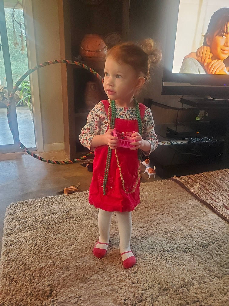 Ember is registered to the contest to win money with this photo: baby_toddler_clothing, child, couch, entertainment_center, event, face, floor, flooring, fun, happy, head, iris, leg, person, skin, sleeve, standing, television, television_set, toddler