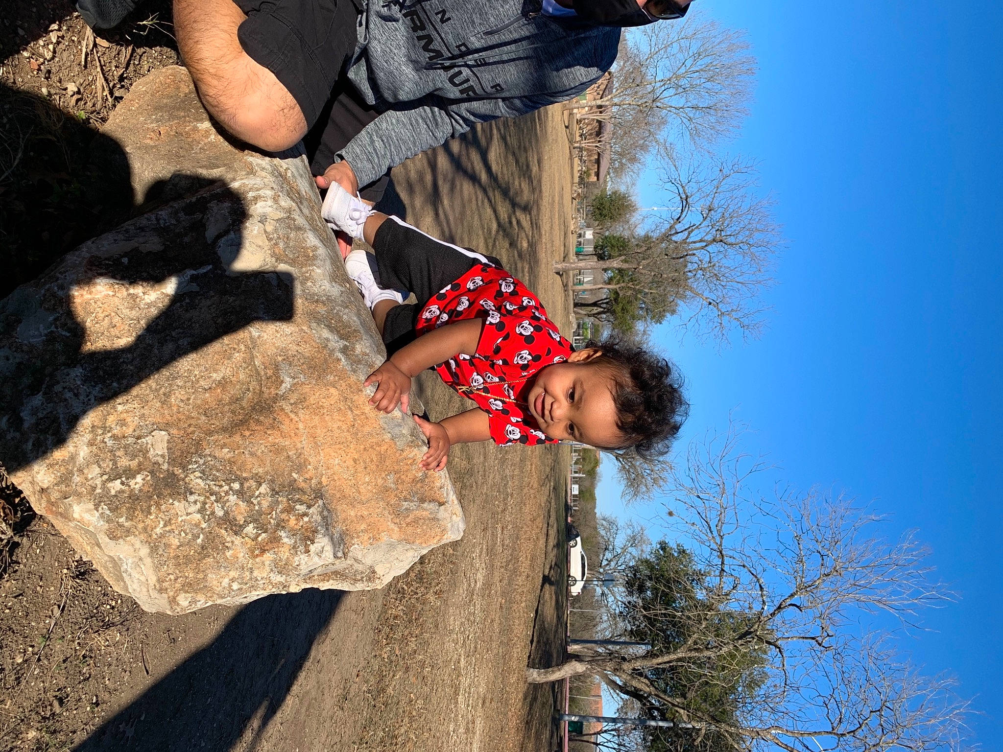 Kyrin is registered to the contest to win money with this photo: adventure, bedrock, blue, extreme_sport, fun, grass, happy, landscape, leisure, people_in_nature, person, recreation, rock, sky, soil, sport_climbing, toddler, travel, tree, winter