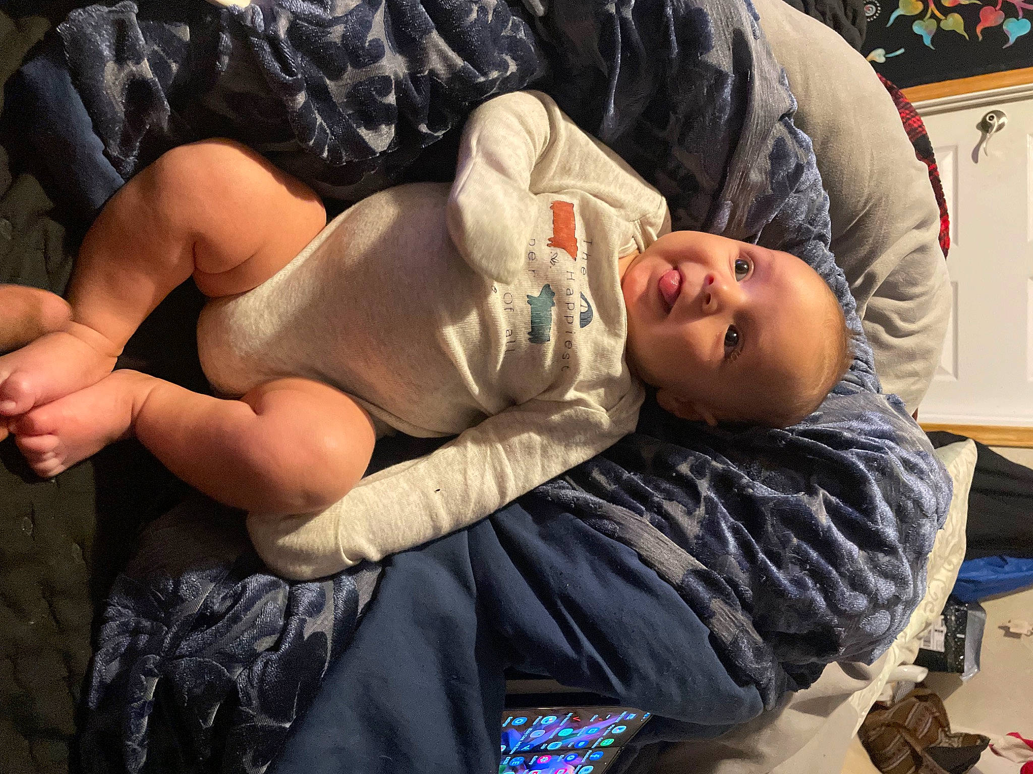 Ares is registered to the contest to win money with this photo: abdomen, barechested, chest, child, comfort, elbow, foot, fun, hairstyle, human_leg, knee, muscle, person, picture_frame, sitting, smile, television, textile, thigh, toddler