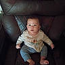 Carson is registered to the contest to win money with this photo: baby, child, infant, sitting, chair, leather_chair, portrait, indoors, face, eyes, wide_eyed, neutral_expression, clothing, shirt, striped_pants, bare_feet, furniture, cushion, front_view, photograph