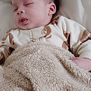 Carson is registered to the contest to win money with this photo: newborn, baby, sleeping, infant, portrait, face, curly_hair, blanket, bed, bedding, cozy, indoors, home, resting, peaceful, closed_eyes, onesie, textile, soft_lighting, vertical_photo