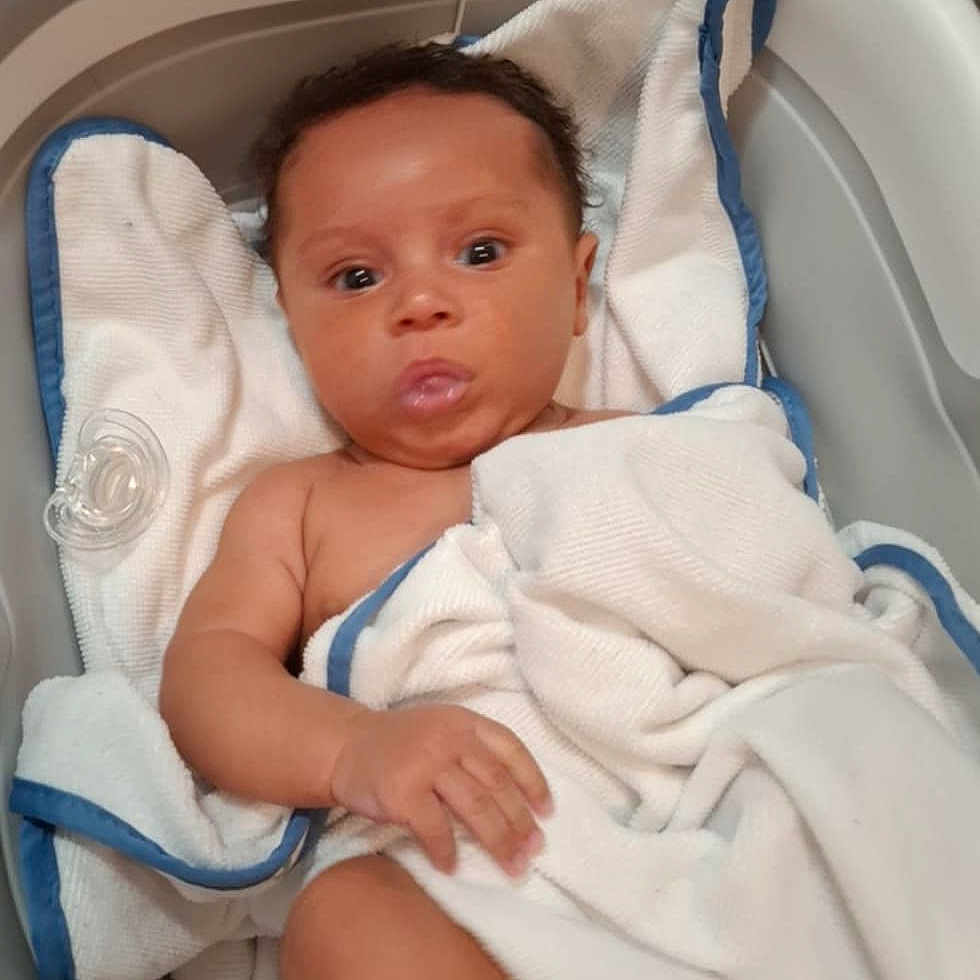 Michael Taylor is registered to the contest to win money with this photo: architecture, baby, bathing, bathtub, bed, blanket, building, crib, face, furniture, head, hospital, infantbed, newborn, person, photography, portrait, sleeping, towel, tub