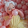 baby, child, yellow_dress, headband, bow, pink_balls, white_balls, playing, cute, adorable, infant, portrait, indoor, soft_lighting, hands, face, smiling, young_child, happy, fun