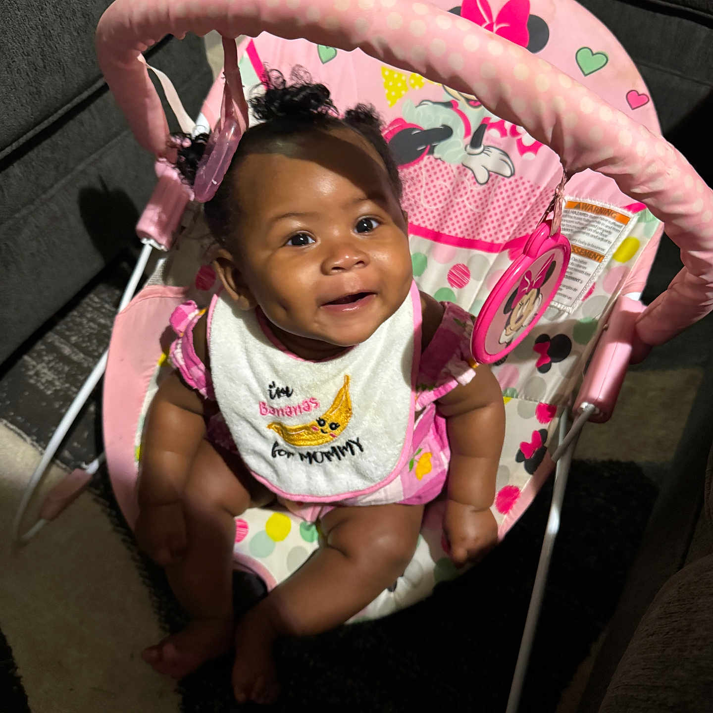 Chrissyah is registered to the contest to win money with this photo: baby, baby_rocker, bib, carpet, cheerful, child, clothing, curly_hair, cute, dimple, furniture, happy, indoor, infant, minnie_mouse, person, pink, seat, smile, toy